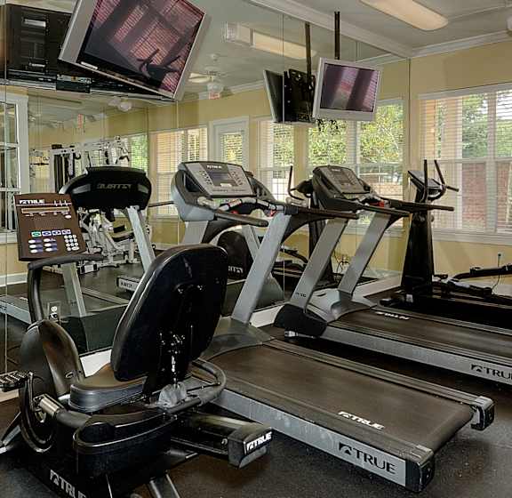 A gym with treadmills and exercise bikes.