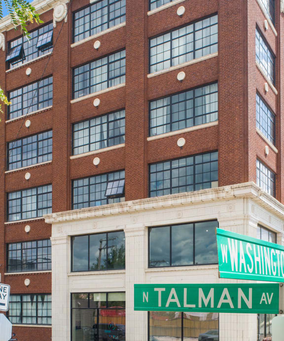 a tall building with a street sign in front of it
