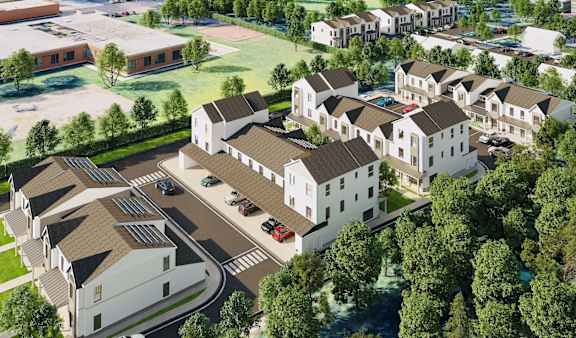A bird's eye view of a residential area with houses and a parking lot.