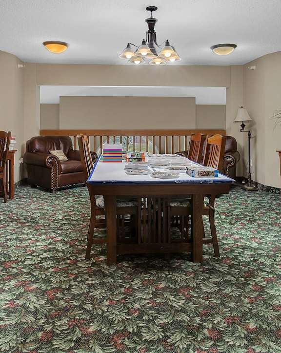 a dining room with a table and chairs