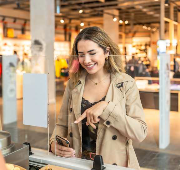 A man and a woman are ordering food at a counter.
