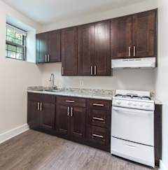 a kitchen with dark wood cabinets and white appliances