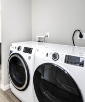 a washer and dryer in a laundry room with a kitchen