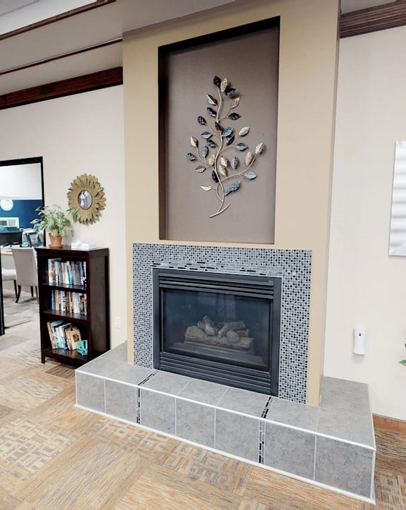 A living room with a fireplace and a chair.