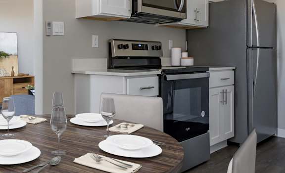 a kitchen and dining area in a 555 waverly unit at Acacia Gardens, Albuquerque, NM, 87111
