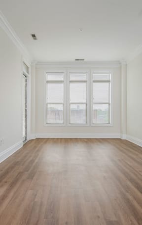 a bedroom with hardwood floors and white walls