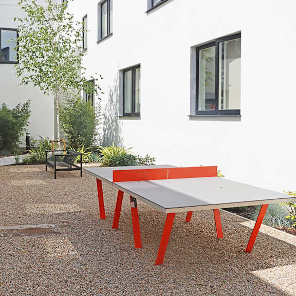 a ping pong table in the courtyard of a house