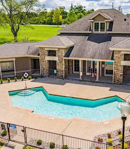 a large swimming pool in front of a house at Highland Hills, Dallas, TX, 75241