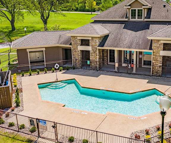 a large swimming pool in front of a house at Highland Hills, Dallas, TX, 75241