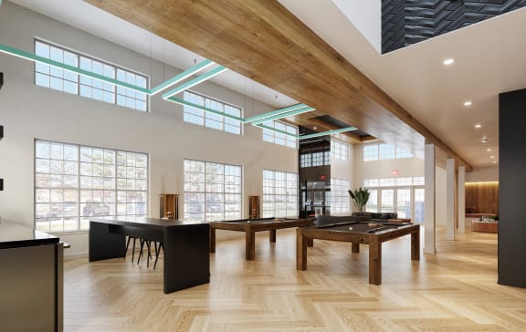a large room with wooden floors and a large table with a ping pong table at Chestnut Hill Village, Pennsylvania