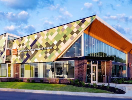 A modern building with a green and yellow patterned facade.