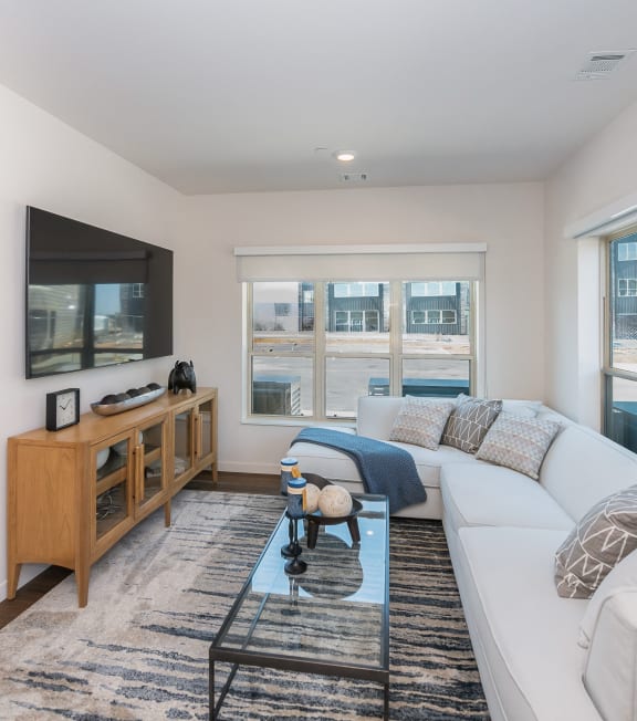 a bed with a blanket and a wooden table in a bedroom  at The Crossings at Windsong, Arizona, 86314
