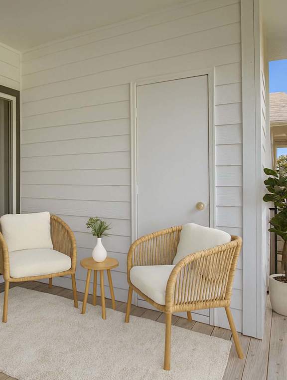 A patio with two chairs and a table.