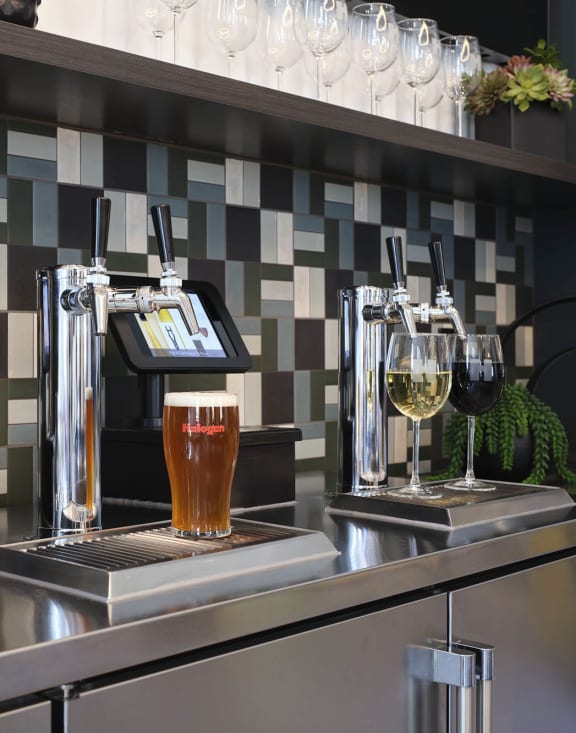a bar with pitchers of beer and glasses on it