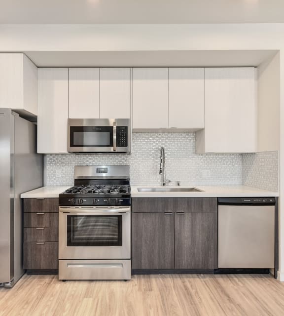 Kitchen with Refrigerator, Hardwood Inspired Floors, Oven, Cabinets and Microwave at Morgan Ranch Apartments, California