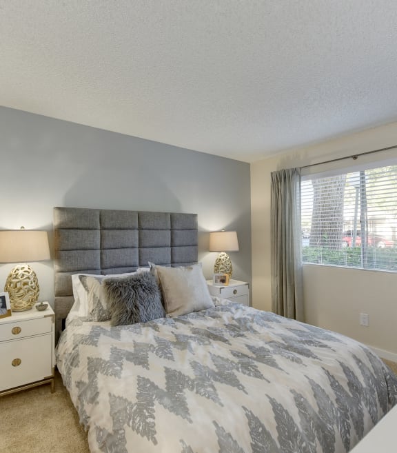 a bedroom with green walls and a white bedspread
