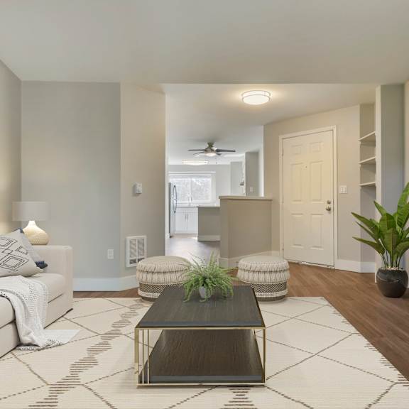an open concept living room and dining area with a white dining table and rattan chairs