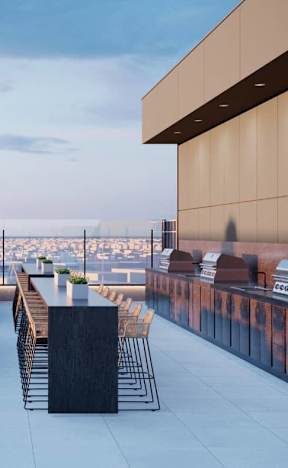A rooftop patio with a fire pit and seating area.