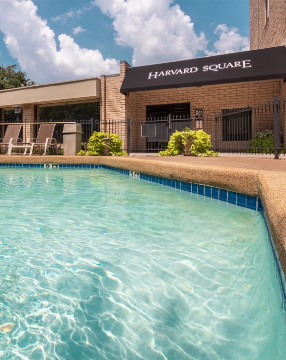 This is a photo of the pool area in the courtyard at Harvard Square Apartments, in the Vickery Meadow neighborhood of Dallas, TX.