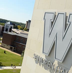 a large wmu sign on the side of a building