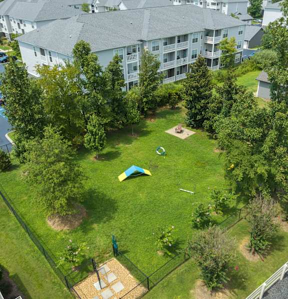 a group of people sitting around a table taking a picture with a tablet at The Haven at Commons Park Apartment , Chattanooga, 37421