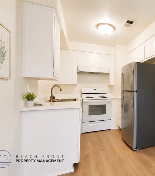 A well-lit, modern kitchen and living room with a dining area.