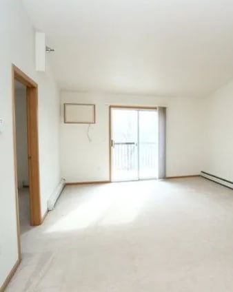 A room with a window and a door.