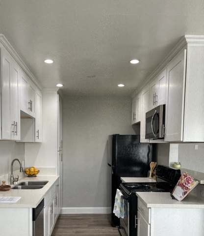 Kitchen with both side which includes the sink and appliances on the opposite side