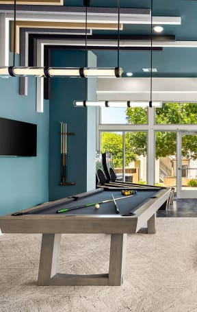 a billiards room with a pool table and couches