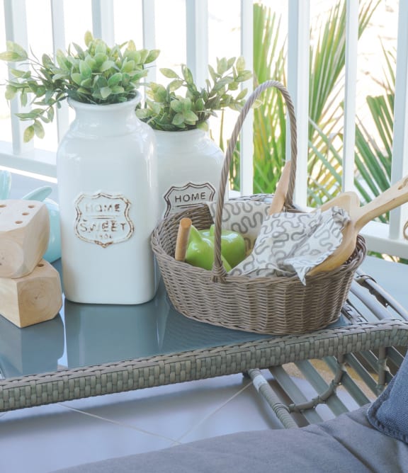 a patio chair with a basket of fruit on a table