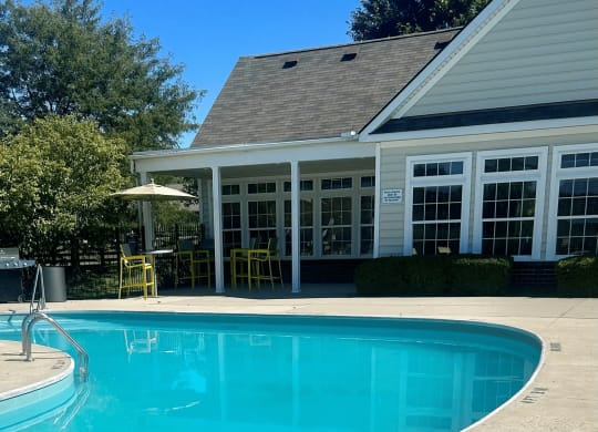a swimming pool with a house in the background at Traditions at Slate Ridge, Reynoldsburg