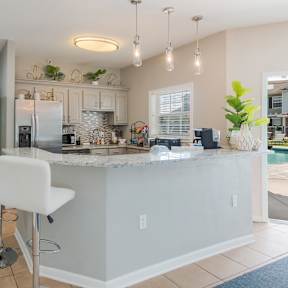 a kitchen with a bar and a living room