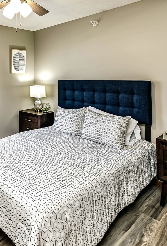 a bedroom with a large bed and a ceiling fan