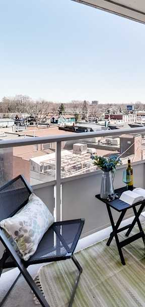 a living room with a couch and a table on a balcony