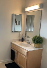 a small bathroom with a sink and a mirror