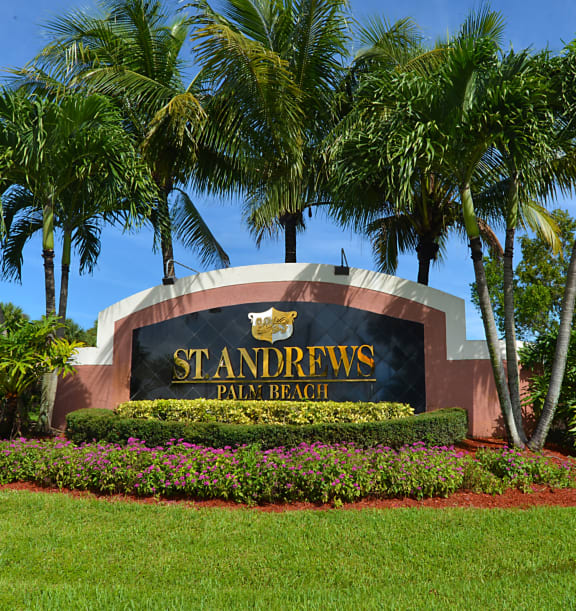 a sign for the st andrews turf park in front of palm trees