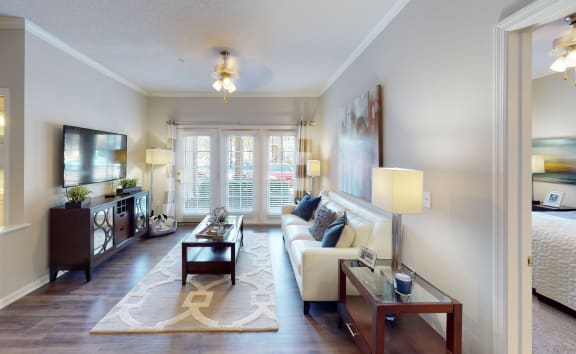 a living room filled with furniture and a large window  at The Preserve at Tampa Palms, Tampa, Florida