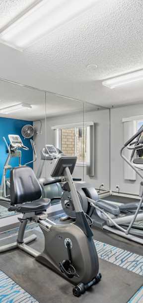 A gym with a treadmill and elliptical machines at Oakwood, Plymouth, 55447