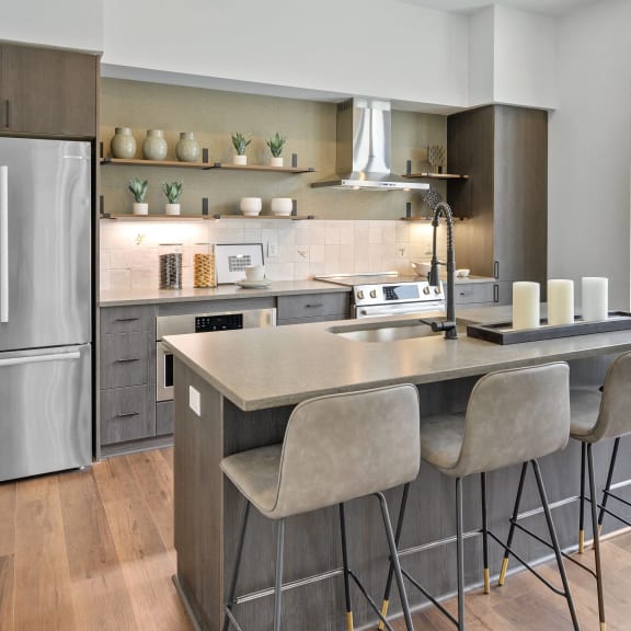 a kitchen with stainless steel appliances and an island with bar stools at Four23/Hoge, Ohio, 45226
