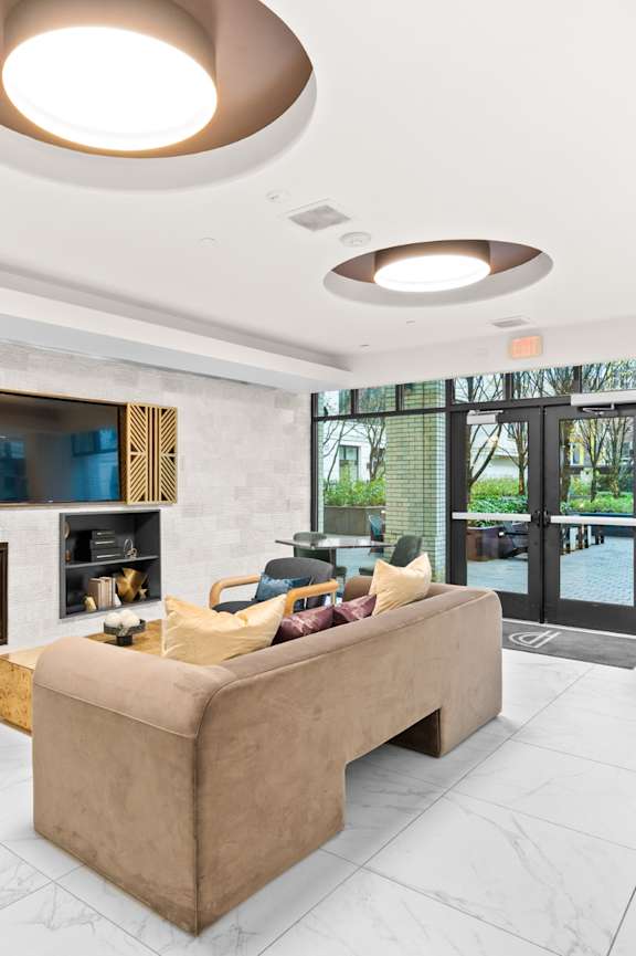 a living room with a fireplace and a television at The Parker in Portland, OR