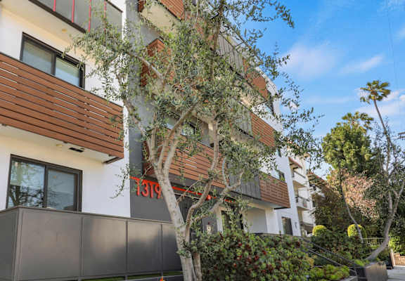 an apartment building with a courtyard in front of it