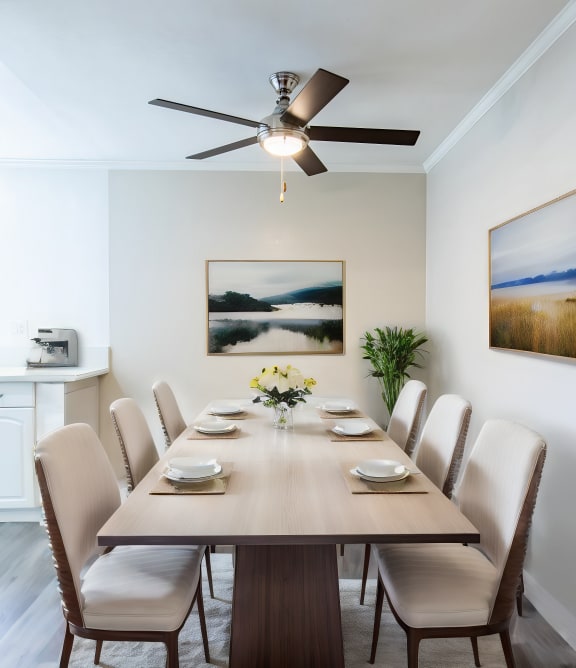 a dining room with a table and chairs and a ceiling fan