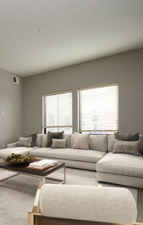 a living room with grey walls and white furniture