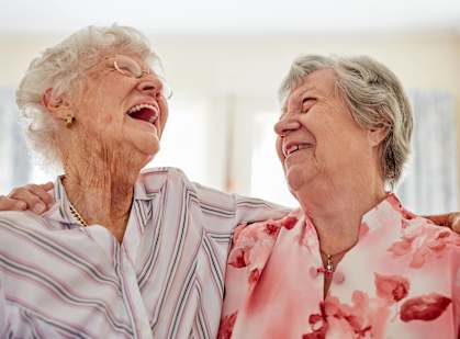 two elderly women laughing while standing next to each otherat Lakeland Hills, Lakeland, FL 33805