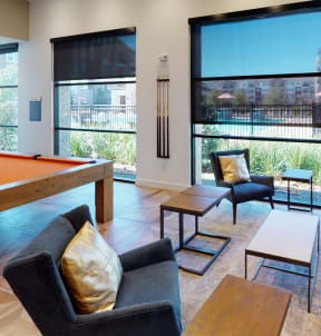 a resident clubhouse with a pool table and flat screen tv