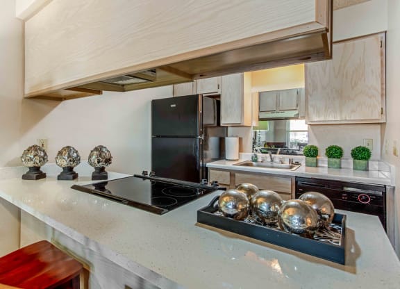 a kitchen with a large counter and a stove top oven