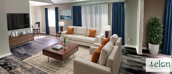 A living room with a white couch and a coffee table.