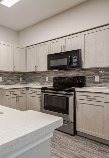 a kitchen with a sink and a stove and a microwave