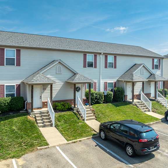 A kitchen with a white stove top oven and a white refrigerator.