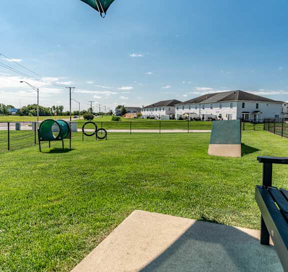 A pet park with a bench and a fence at Mallard Bay Apartments, Crown Point, Indiana, 46307